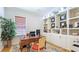 A home office with a wooden desk, built-in shelves, and ample natural light at 9226 13Th Avenue Nw Cir, Bradenton, FL 34209