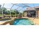 Stunning screened-in pool and spa area with an outdoor grill and lounging area at 9226 13Th Avenue Nw Cir, Bradenton, FL 34209
