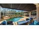 Beautiful screened-in pool with an outdoor kitchen and a tanning ledge with lounge chairs at 9226 13Th Avenue Nw Cir, Bradenton, FL 34209
