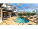 Screened in pool boasts hot tub, lounging area and outdoor dining with mature landscaping at 9226 13Th Avenue Nw Cir, Bradenton, FL 34209