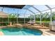 Gorgeous screened pool features an outdoor kitchen and tanning deck with lounge chairs at 9226 13Th Avenue Nw Cir, Bradenton, FL 34209