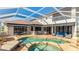 Beautiful screened-in pool and patio area with outdoor seating and spa at 9226 13Th Avenue Nw Cir, Bradenton, FL 34209