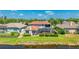 Exterior rear view showing a screened in porch with a grassy yard leading to the canal at 9226 13Th Avenue Nw Cir, Bradenton, FL 34209