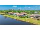 Exterior rear view showing a screened in porch with a grassy yard leading to the canal at 9226 13Th Avenue Nw Cir, Bradenton, FL 34209