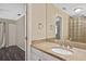 Bathroom vanity with granite countertops and view into the bedroom at 1011 Bacon Ave, Sarasota, FL 34232
