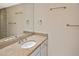 Granite countertop vanity featuring a towel rack, mirror and vanity lights at 1011 Bacon Ave, Sarasota, FL 34232