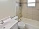 Tiled bathroom featuring a shower, toilet and single sink vanity at 1011 Bacon Ave, Sarasota, FL 34232