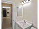 Bathroom vanity with stainless faucet, looking into the adjacent kitchen area at 1011 Bacon Ave, Sarasota, FL 34232