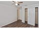 Bedroom featuring wood-look flooring, a ceiling fan, and a closet with white doors at 1011 Bacon Ave, Sarasota, FL 34232