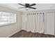 This cozy bedroom features a ceiling fan and two closets with wood-look vinyl flooring at 1011 Bacon Ave, Sarasota, FL 34232