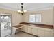 View of the dining area with built-in cabinets and sliding doors to the screened patio at 1011 Bacon Ave, Sarasota, FL 34232