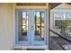 Inviting glass double doors lead into this charming home, offering natural light and a glimpse of the interior at 1011 Bacon Ave, Sarasota, FL 34232