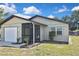 Charming single-story home featuring a screened porch, attached garage, and a well-maintained lawn at 1011 Bacon Ave, Sarasota, FL 34232