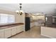 View of the kitchen featuring white cabinets and a black refrigerator open to the dining area at 1011 Bacon Ave, Sarasota, FL 34232