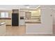 Bright kitchen features white cabinetry, granite countertops, and a black refrigerator at 1011 Bacon Ave, Sarasota, FL 34232