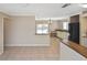 Open-concept kitchen and dining area with tile floors and a view to the backyard at 1011 Bacon Ave, Sarasota, FL 34232