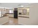 Bright kitchen with white cabinetry, black refrigerator, and tile floors throughout at 1011 Bacon Ave, Sarasota, FL 34232