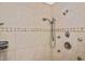 This beige-tiled shower features dual shower heads with oil-rubbed bronze fixtures at 1011 Bacon Ave, Sarasota, FL 34232