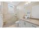 Bathroom featuring walk-in shower, stone flooring, granite countertops, and white cabinetry at 1021 Crescent St # 1, Sarasota, FL 34242