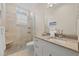 Bright bathroom featuring a glass shower, stone flooring, and granite countertops at 1021 Crescent St # 1, Sarasota, FL 34242