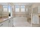 Luxurious bathroom featuring a soaking tub, walk-in shower, and double vanity at 1021 Crescent St # 1, Sarasota, FL 34242
