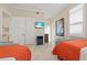 Bright bedroom with tile flooring, coastal decor, and a mounted television at 1021 Crescent St # 1, Sarasota, FL 34242