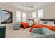 Bright bedroom with twin beds, shuttered windows, ceiling fan and coastal decor at 1021 Crescent St # 1, Sarasota, FL 34242