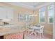 Charming breakfast nook with white table, bright windows, and views to the outside at 1021 Crescent St # 1, Sarasota, FL 34242
