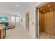 Hallway featuring travertine floors, an elevator and a view into the light-filled living room at 1021 Crescent St # 1, Sarasota, FL 34242