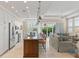 Open concept kitchen area features stainless steel appliances, granite countertops, and eat-in island at 1021 Crescent St # 1, Sarasota, FL 34242