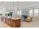 Kitchen island featuring stainless steel appliances, and a bar that opens to the living room area at 1021 Crescent St # 1, Sarasota, FL 34242