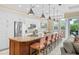 Spacious kitchen with stainless steel appliances, granite countertop island, and comfortable bar stool seating at 1021 Crescent St # 1, Sarasota, FL 34242