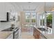 Modern kitchen with granite counters, stainless steel appliances, and adjacent dining area at 1021 Crescent St # 1, Sarasota, FL 34242
