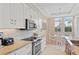 Modern kitchen with stainless steel appliances, tile backsplash, granite countertops, and dining area at 1021 Crescent St # 1, Sarasota, FL 34242