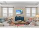 Cozy living room with plantation shutters, comfortable seating and TV for relaxing at 1021 Crescent St # 1, Sarasota, FL 34242
