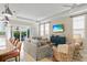 Bright living room featuring comfortable seating, a large TV, and access to an outdoor balcony at 1021 Crescent St # 1, Sarasota, FL 34242