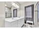 Bright bathroom with double sink vanity, a large mirror, and a glass enclosed shower with tiled accents at 10616 High Noon Trl, Parrish, FL 34219