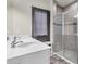 Modern bathroom featuring a double sink vanity, a glass enclosed shower with gray tiling, and a window at 10616 High Noon Trl, Parrish, FL 34219