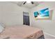 Relaxing bedroom with mounted TV and a comfortable bed dressed in neutral tones and soft bedding at 10616 High Noon Trl, Parrish, FL 34219