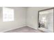 Empty bedroom with neutral carpet and paint and a large mirror on the wall with an open door to the room at 10616 High Noon Trl, Parrish, FL 34219
