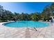 Large community pool with fountains and surrounding lounge chairs, providing a relaxing and luxurious outdoor experience at 10616 High Noon Trl, Parrish, FL 34219