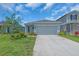Charming single-story home featuring a well-maintained lawn and a two-car garage at 10616 High Noon Trl, Parrish, FL 34219