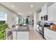 Bright kitchen featuring granite countertops, an island with seating, and modern appliances at 10616 High Noon Trl, Parrish, FL 34219
