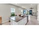 Open kitchen design with a large island offering seating and views of the living room at 10616 High Noon Trl, Parrish, FL 34219