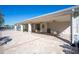 A covered patio area with tables and chairs near the community pool, perfect for relaxing and enjoying outdoor meals at 10616 High Noon Trl, Parrish, FL 34219