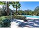 Poolside shower and well-kept landscaping are adjacent to the inviting community pool perfect for relaxation and enjoyment at 10616 High Noon Trl, Parrish, FL 34219