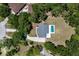 Overhead view of a home featuring a private pool, surrounded by mature trees and lush landscaping at 10712 Forest Run Dr, Bradenton, FL 34211