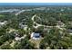 Stunning aerial shot of a community with tree lined streets and beautiful houses with pools at 10712 Forest Run Dr, Bradenton, FL 34211