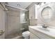 Well-lit bathroom featuring a glass-enclosed shower and white vanity at 10712 Forest Run Dr, Bradenton, FL 34211