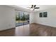 Bright bedroom with wood floors and views of the private backyard and screened porch at 10712 Forest Run Dr, Bradenton, FL 34211